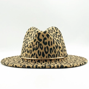Close-up of leopard print fedora hat featuring a gold metallic band and felt texture
