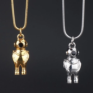 Close-up of hip-hop astronaut pendants in gold and silver finish with metal snake chains