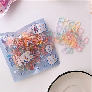 Detail of colorful elastic hair bands in cute cartoon packaging for children's hairstyles