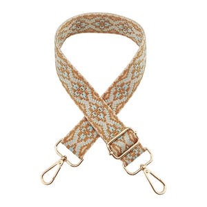 Close-up of bohemian geometric jacquard bag strap with gold metal lobster clasps