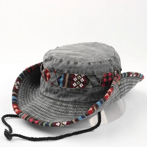 Detail of grey denim sun hat with colorful ethnic embroidery and adjustable wind cord