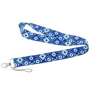 Detailed close-up of blue fabric lanyard featuring traditional Turkish evil eye patterns