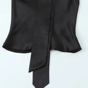 Elegant black satin shirt with decorative hem tie detail on a clean white background