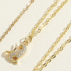 Macro shot of gold-plated cheetah pendant necklace encrusted with white zircon stones