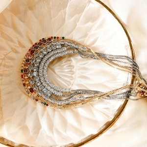 Luxurious layered adjustable bracelets with gold and silver accents and colorful gemstones