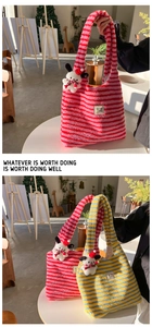 Detailed view of the striped plush tote bag featuring a cute cartoon dog mascot charm
