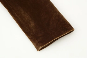 Macro detail of dark brown velvet sleeve cuff showing soft texture and premium glossy finish