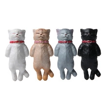 Detailed view of four colorful miniature reclining cat figurines with red collars