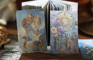 Detailed macro view of vintage cards featuring gold throne and dreamcatcher motifs