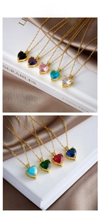 Close-up of heart-shaped crystal necklaces in multiple colors with gold-plated chains