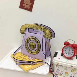 Detail of creative vintage telephone crossbody bag in lavender purple with golden sequins