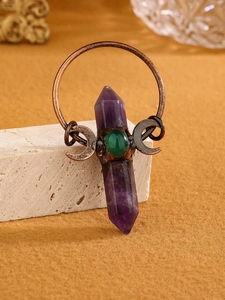 Detail of vintage bronze pendant with amethyst pillar, green chalcedony and moon motifs