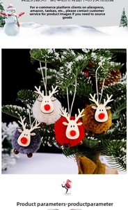 Detailed view of four colorful felt reindeer ornaments hanging on a green Christmas tree
