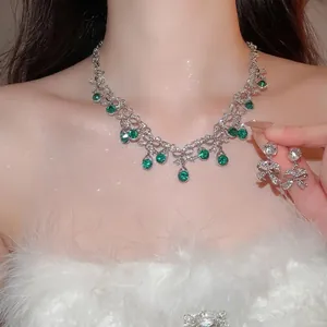 Elegant palace style jewelry set with green teardrop stones and bow necklace