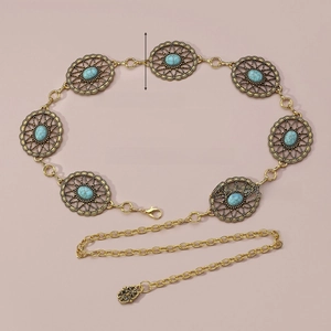 Detail view of Bohemian metal chain belt with turquoise inlays and ornate hollow carvings