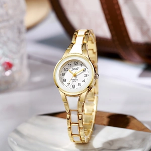 Close-up of gold and white link strap on an elegant quartz watch for women