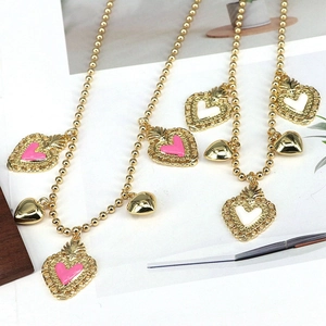 French style gold beaded necklaces with pink and white enamel heart pendants in a stylish setup