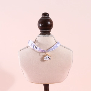 Detail of purple floral pet collar with cloud charm on professional mannequin