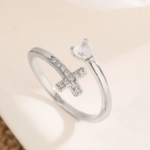 Silver open ring with heart and cross motif and zircon inlay shown from 45-degree angle