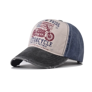 Detail of distressed baseball cap featuring vintage motorcycle print and denim texture