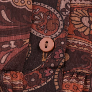Vintage paisley print maxi dress with V-neck and decorative button in warm earth tones