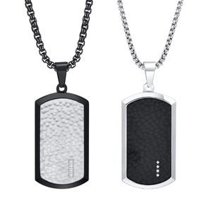 Detailed view of military dog tag necklaces with hammered texture and rhinestone inlay