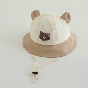 Close-up of bear ears and plush embroidery on cotton canvas baby bucket hat