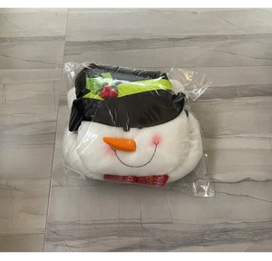 Detailed view of plush snowman Christmas tree topper in transparent protective packaging