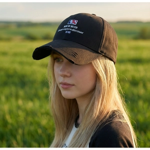Distressed black cotton baseball cap with white NOW OR NEVER embroidery and vintage details