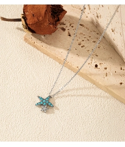 Close-up of S925 sterling silver starfish pendant with turquoise and small zircon stones