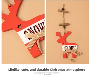 Detail of red wooden reindeer Christmas ornament with SNOW text and a small bell