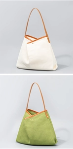 Detail of cream and sage green tote bags with textured fabric and leather handles