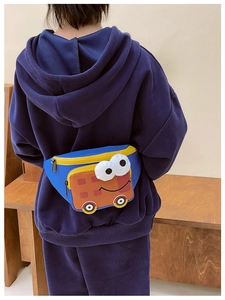 Detailed view of the blue nylon kids crossbody bag with orange cartoon bus pocket