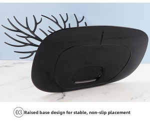 Detail view of the heightened non-slip base on black antler jewelry organizer stand