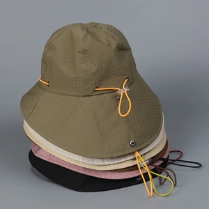 Detail showing tear-resistant nylon fabric texture and drawstring on outdoor bucket hats