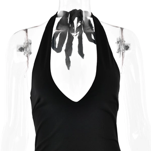 Detail of black halter dress with deep V-neck and backless tie-up design on mannequin