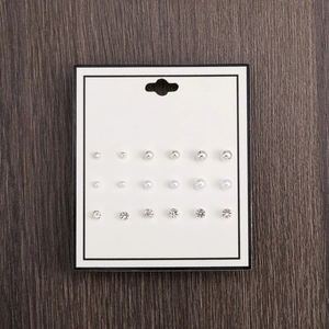 18-pair pearl and rhinestone stud earring set displayed on white card over dark wood