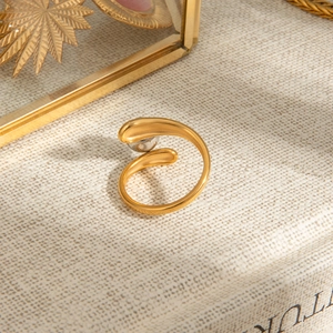 Two-tone gold and silver stainless steel open ring with bead detail on textured surface