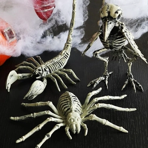 Halloween decorative skeleton set including scorpion, bird, and spider on pumpkin background