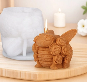 Detailed view of the bee and rose flower candle with its white silicone DIY mold