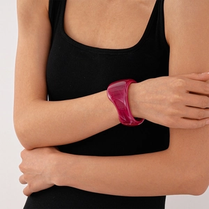 Close-up of retro irregular purple acrylic bangle on model with bold geometric design