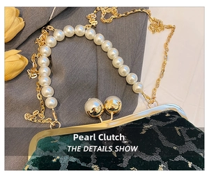 Detailed macro view of dark green velvet shell bag with gold metallic texture and pearl clasp