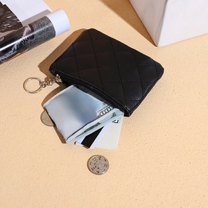 Close-up of black quilted zip coin purse showing card slots and cash storage details