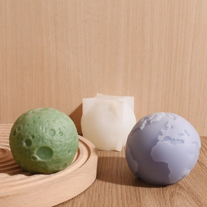 Macro detail of 3D globe and moon silicone molds for DIY scented candles and planet ornaments
