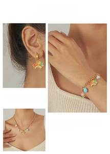 Detailed look at multi-element jewelry set with happy rainbow charms and floral accents