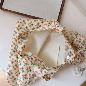 Detailed view of floral canvas tote bag featuring magnetic clasp and inner pocket