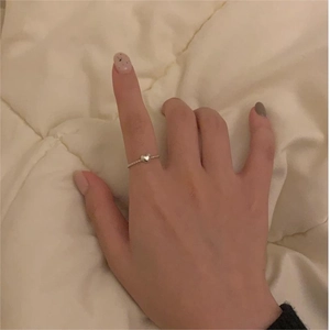 Detailed view of minimalist S925 sterling silver heart ring worn on finger