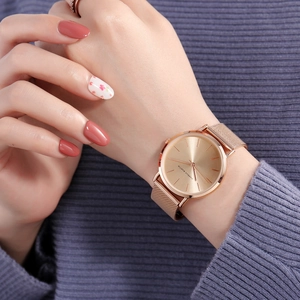 Minimalist 36mm gold mesh band waterproof quartz watch worn on a woman's wrist