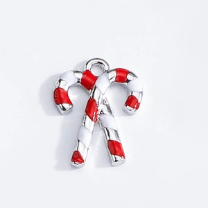 Close-up of red and white enamel candy cane charms for Christmas DIY jewelry making