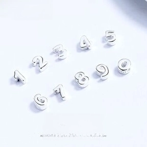 Detailed macro view of S925 sterling silver numbered 0-9 DIY jewelry accessories